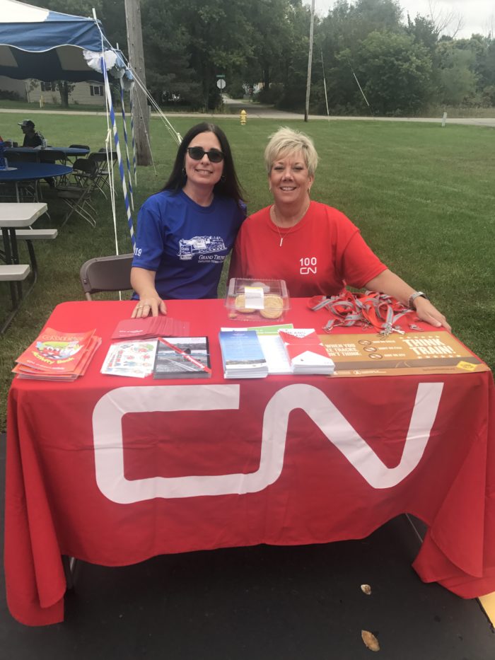 Ladies sitting at an information table